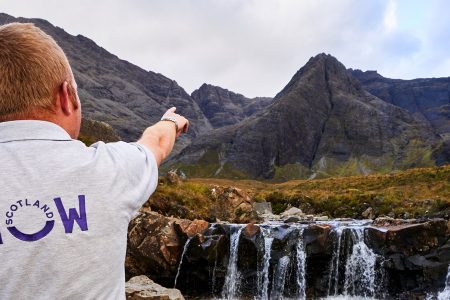 Group of tourists and guide at the Fairy Pools on Isle of Skye