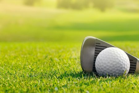 Close up of golf club and ball on the grass