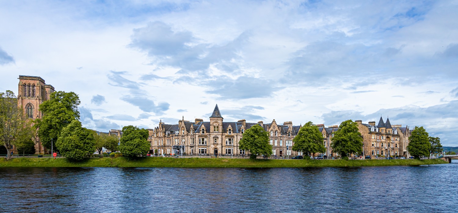 Inverness Castle reflecting on the water of the River Ness, Scotland