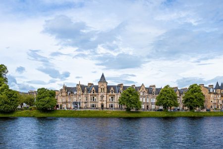 A stunning view of a huge castle overlooking a beautiful Loch