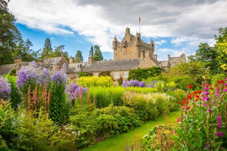 A stunning image of a fairytale castle surrounded by a colourful garden