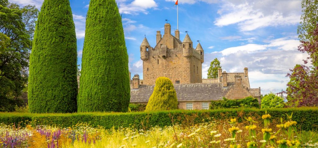 A bright image of a castle surrounded by trees