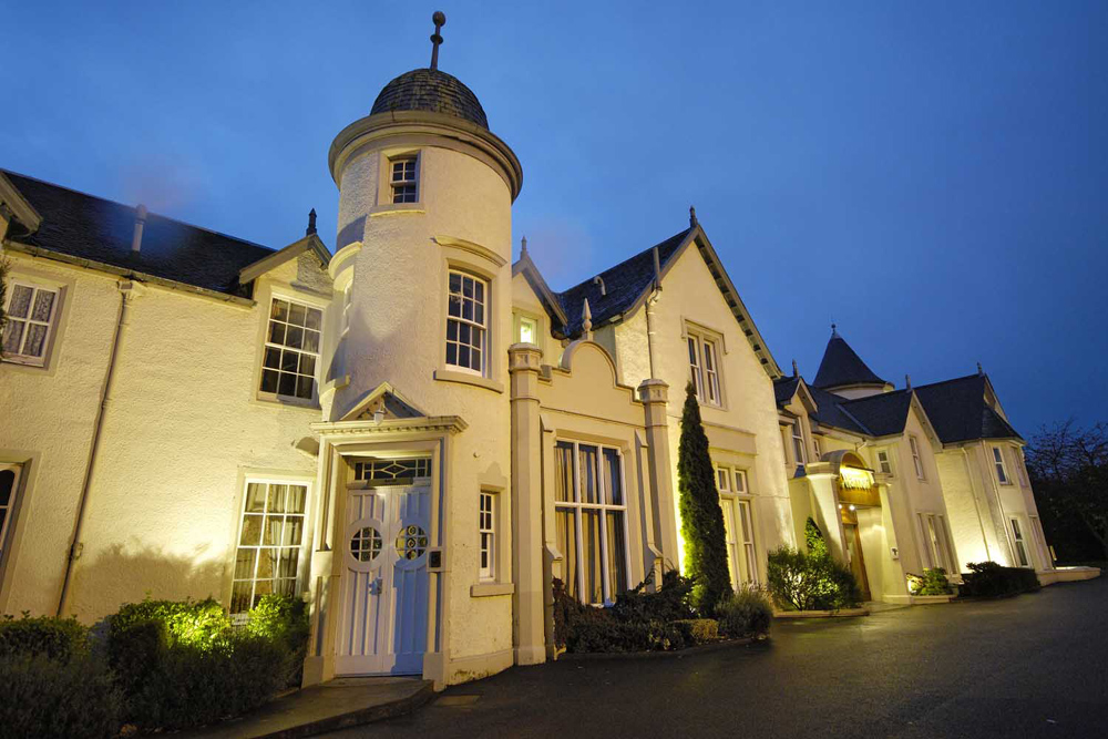 Exterior view of The Kingsmills Hotel in Inverness at night