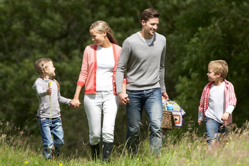 A family taking a picnic to the park