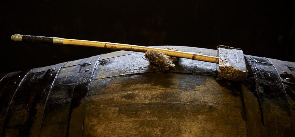 A cask of whisky with a hammer