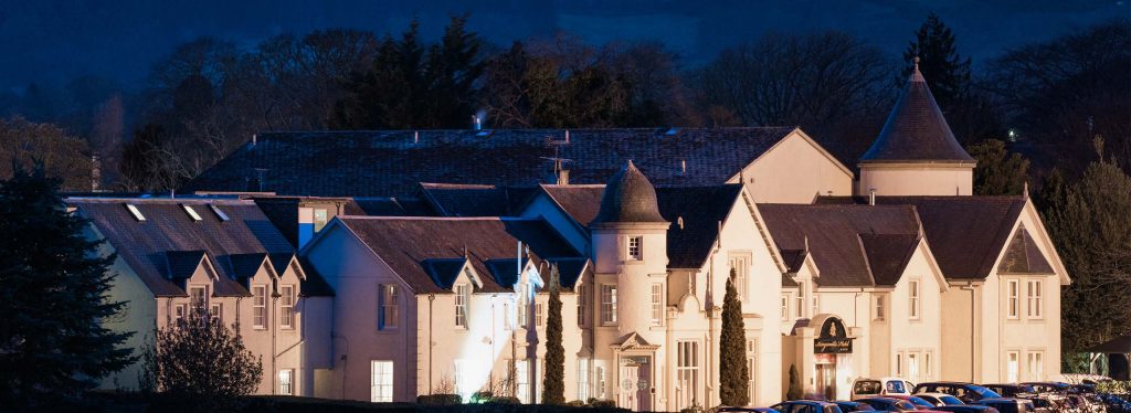 The exterior of Kingsmills Hotel in Inverness at night