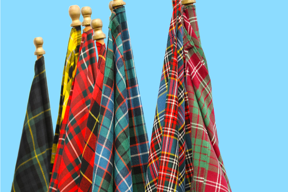 Scottish tartan flags against a blue sky