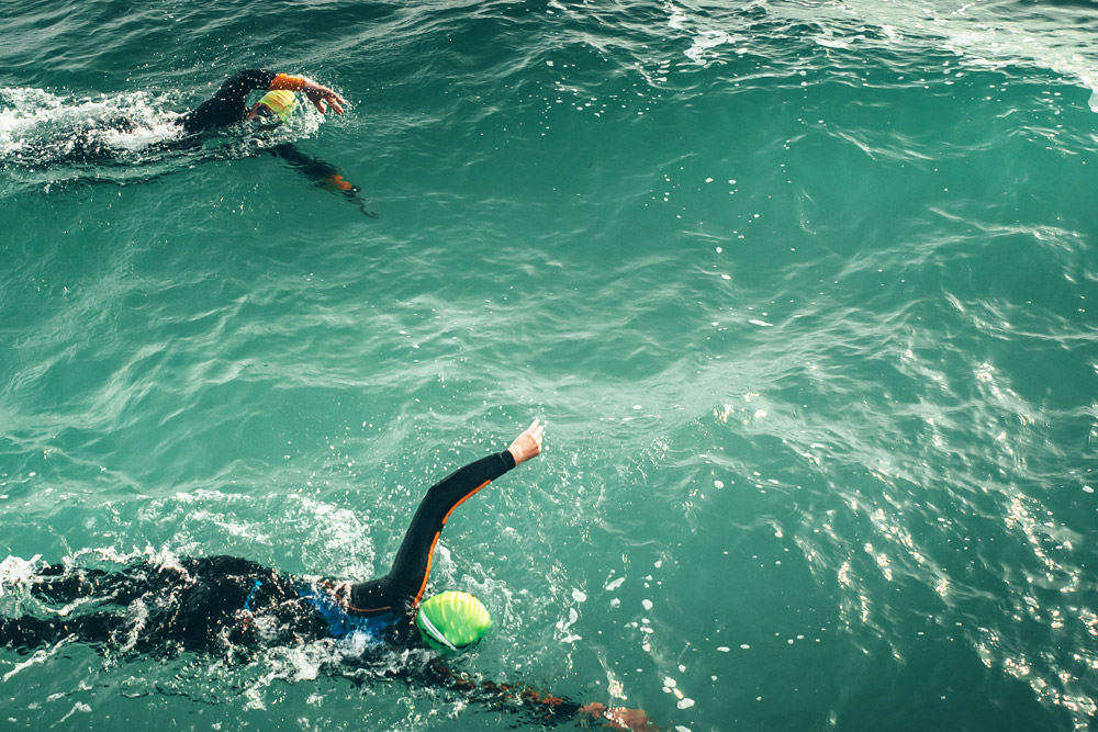 Friends swimming together in open water