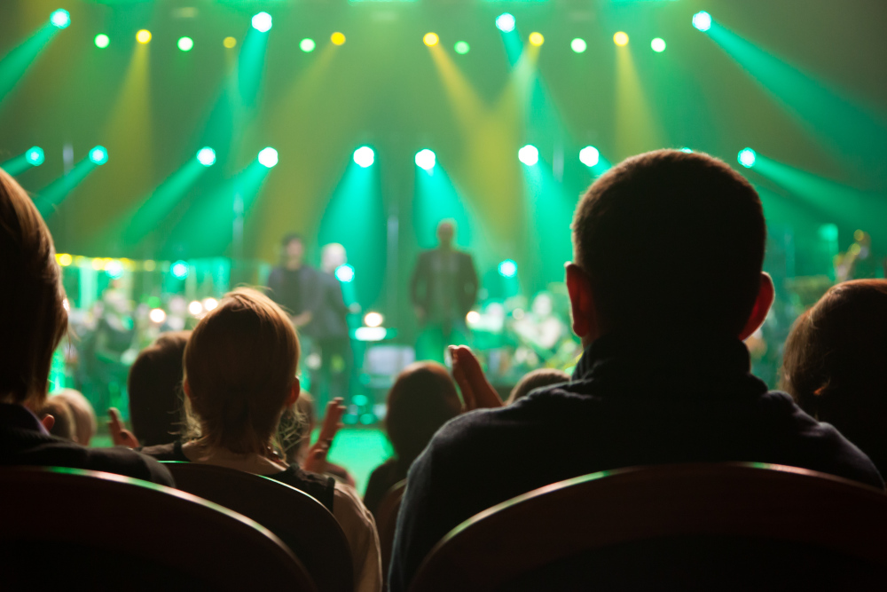 Audience applauding a live stage show at the theatre