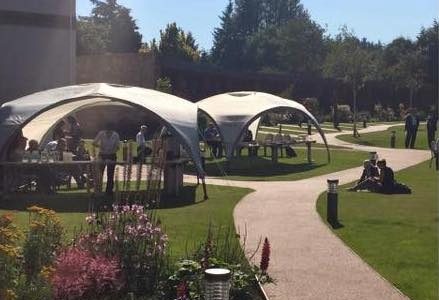 Delegates enjoying a coffee break in the gardens of the Kingsmills