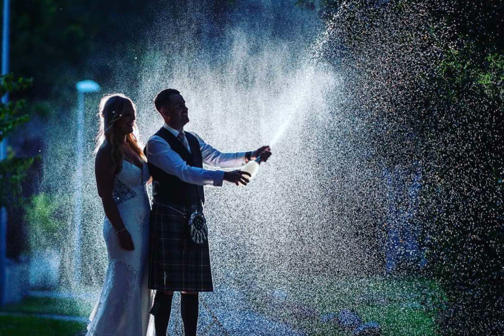 Wedding couple in the rain at the Kingsmills Hotel