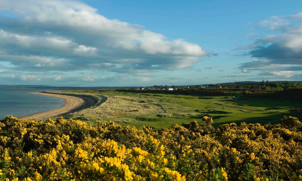 Royal Dornoch Golf Course with hole in foreground and beach in distance