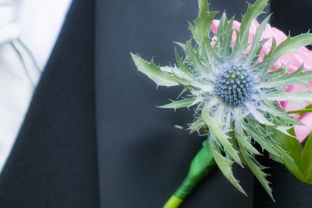 Close up of thistle buttonhole at a Scottish wedding