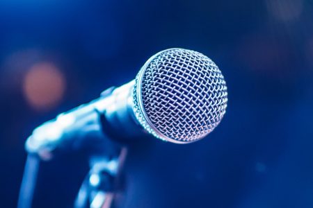 Microphone on stage with blue background