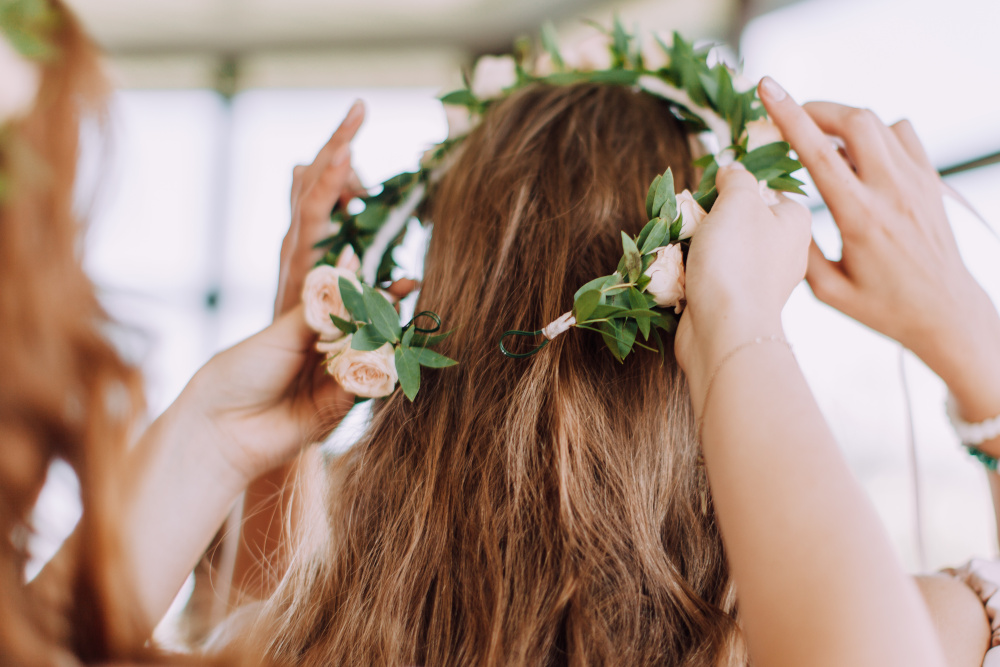 Bride putting on a flower crown