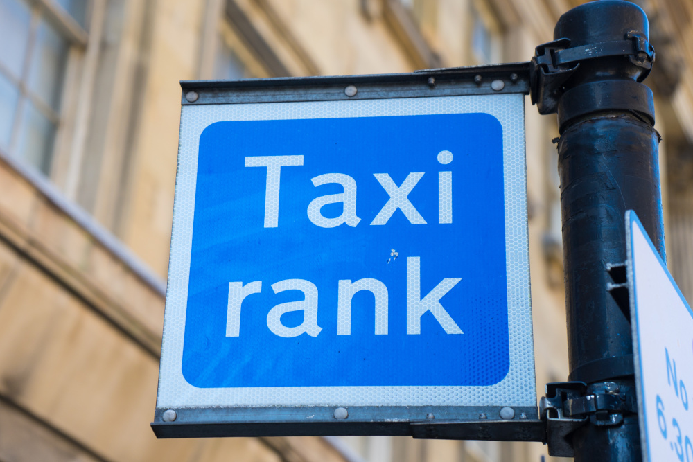 Blue taxi rank sign in a city