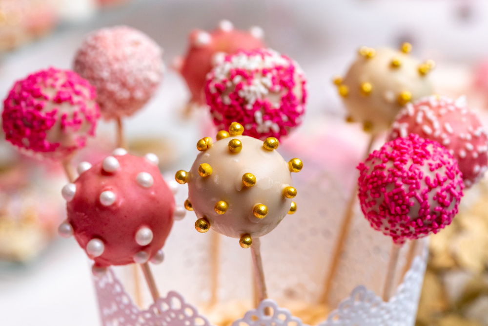 Beautifully decorated cake pops on a wedding table