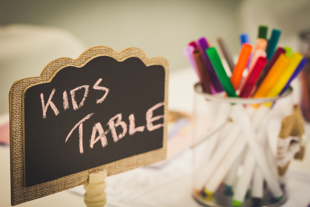 Kids table set up with pens and activities