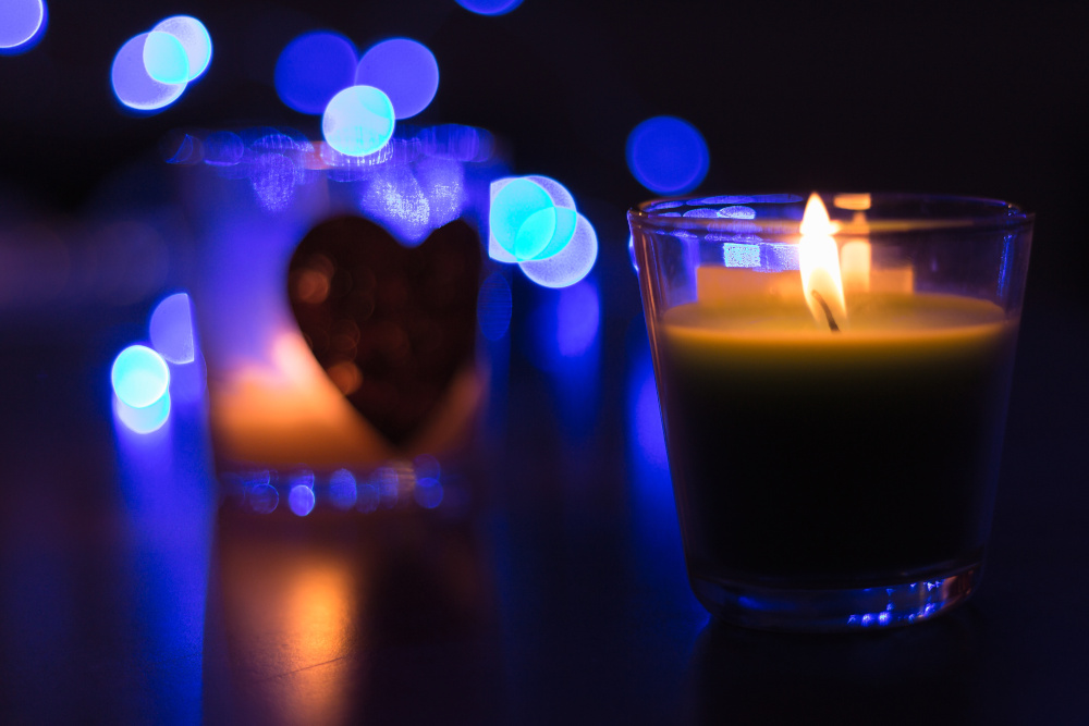 Indoor candle with love heart and blue background