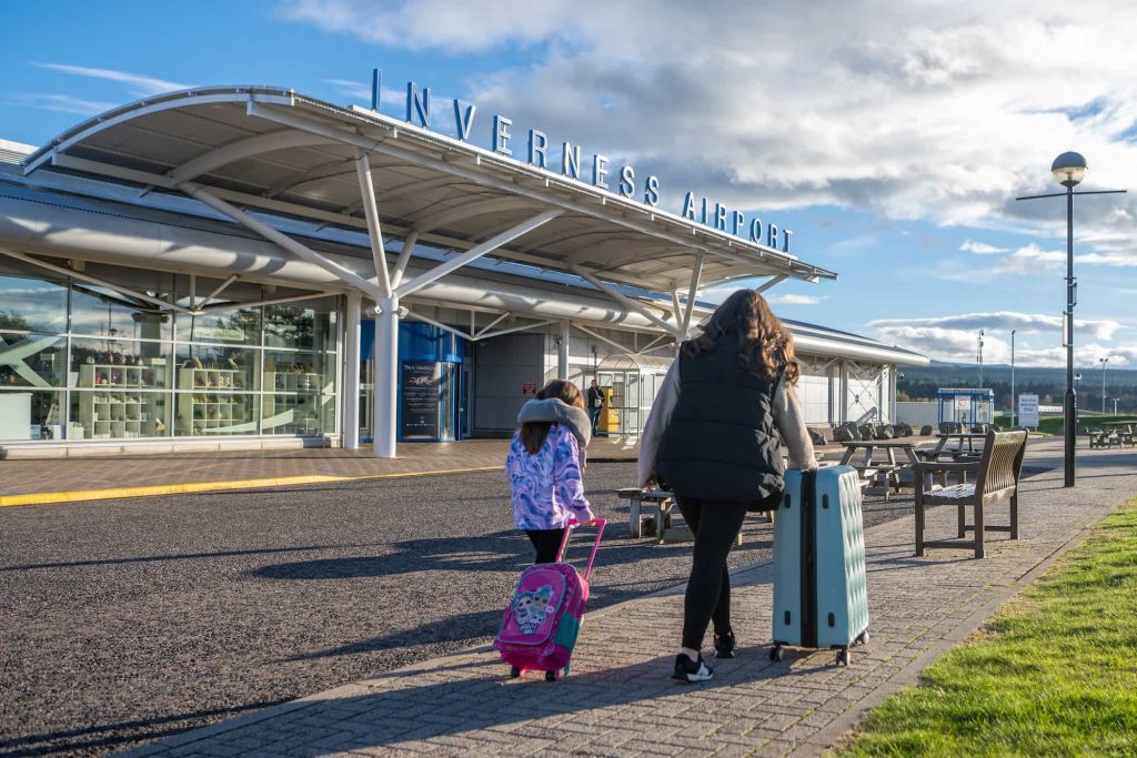 Family walking into Inverness airport