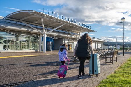 Family walking into Inverness airport