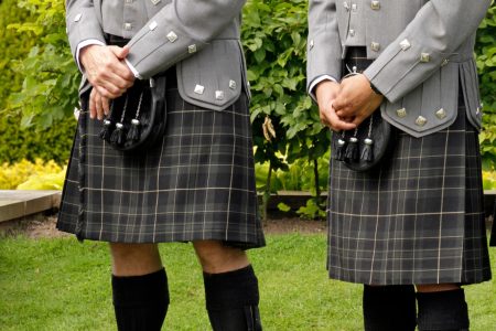 Groomsmen in grey kilts in gardens