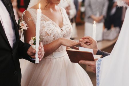 Elegant bride and groom exchanging rings