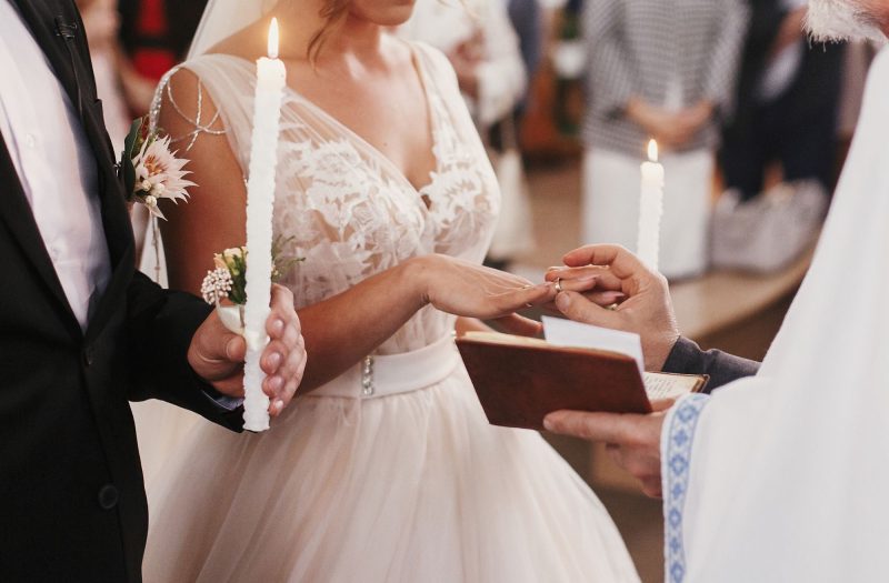 Elegant bride and groom exchanging rings