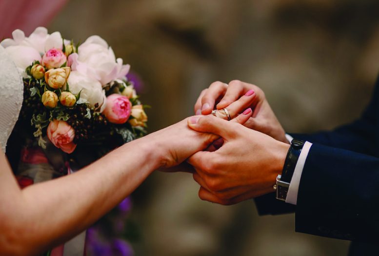 Private Concierge Scotland helping couples create their perfect wedding day; image includes a bride with her bouquet and her husband putting a ring on her finger