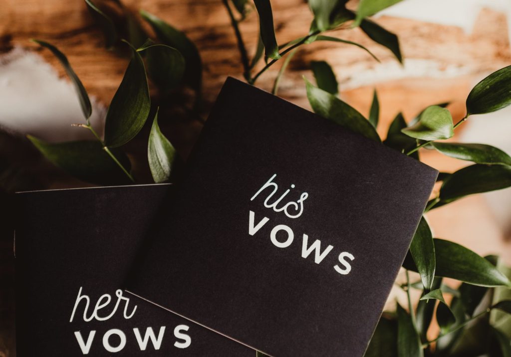 Wedding vows cards with flowers in background