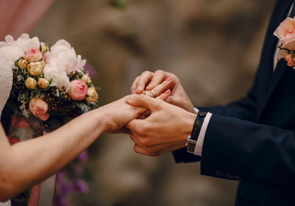 Couple exchanging rings on their elegant wedding day