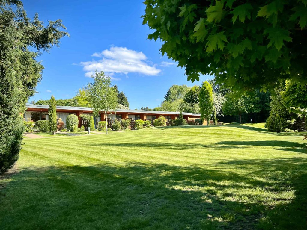 Garden Rooms at Kingsmills Hotel with lush green lawn in foreground