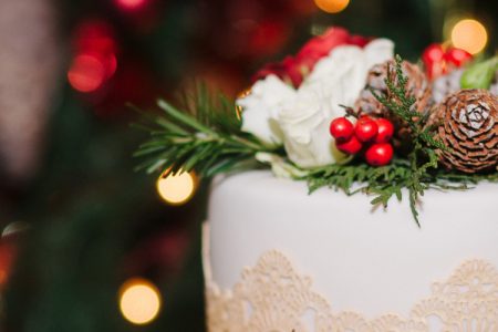 Wedding cake decorated with cones, pine, flowers and berries