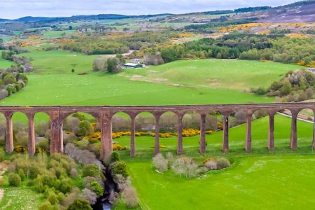 An aerial panorama view up the River Nairn towards the railway viaduct