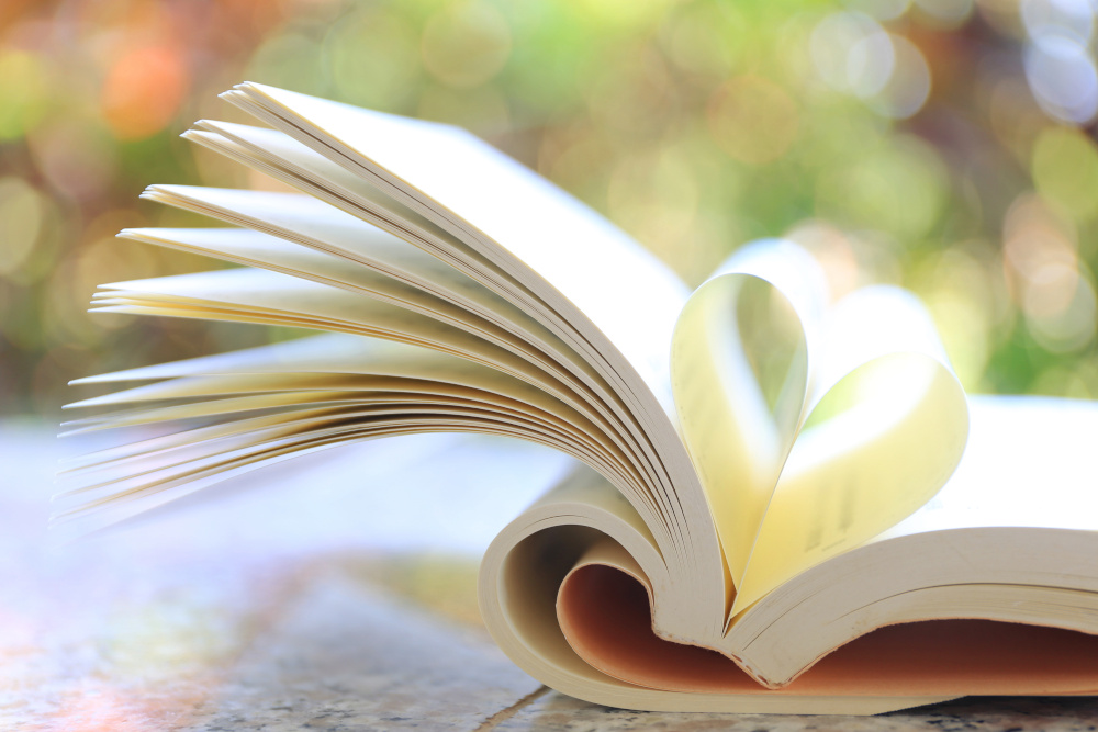 A book with open pages forming a heart shape