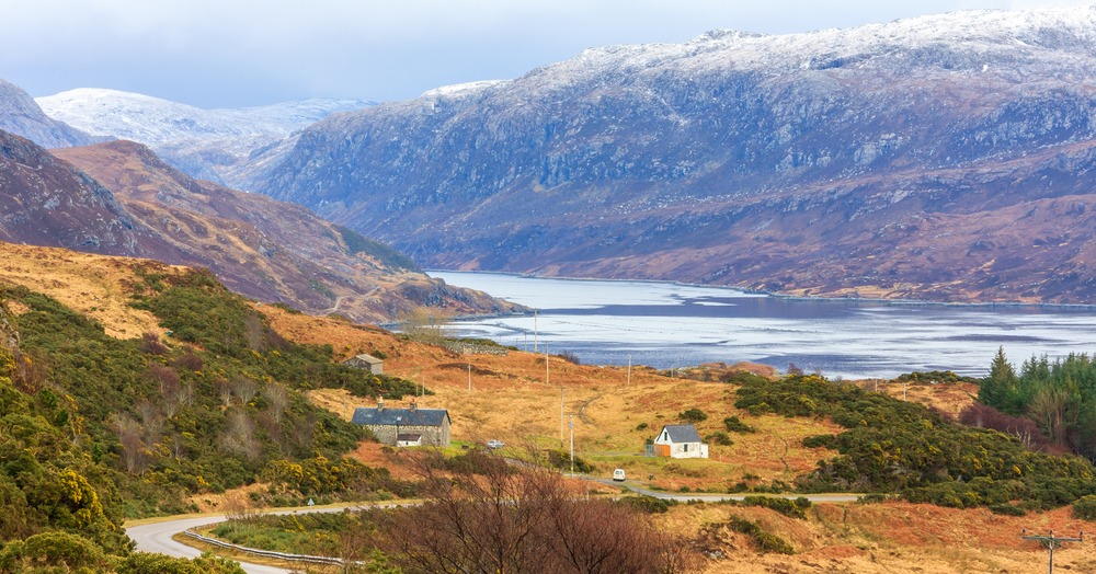 Winter landscape of Loch Ness and the Highlands with snow capped hills.