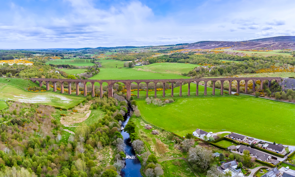 An aerial panorama view up the River Nairn towards the railway viaduct at Nairn, Scotland on a summers day.