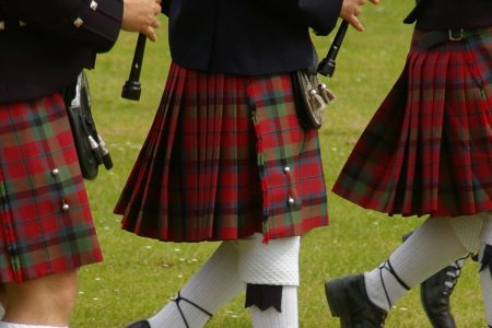 Scottish kilted pipers marching