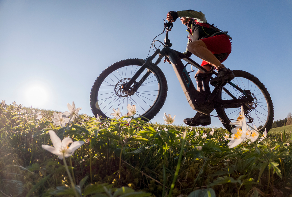 woman riding her electric mountain bike in early springtime.