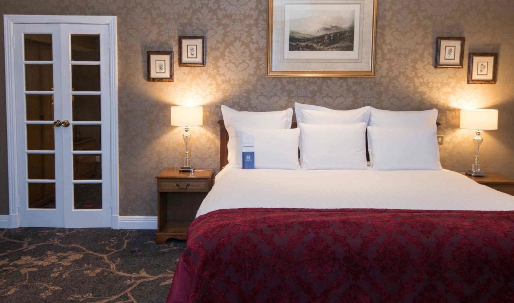 A bed in one of the classic accessible rooms of the Kingsmills Hotel, a luxury hotel in Inverness.