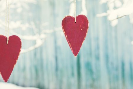 Two love hearts against a winter background