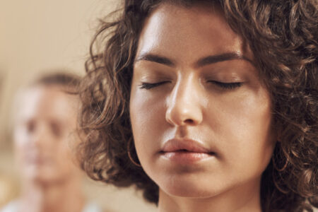 Group with eyes closed, pracising mindfulness