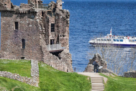 Boat cruise sailing past Urquhart Castle
